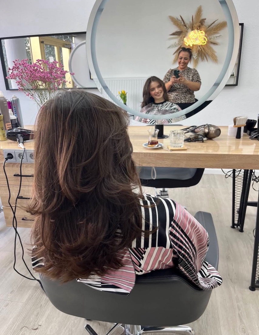 Lange, braune Haare mit weichen Stufen nach dem Styling bei Saime